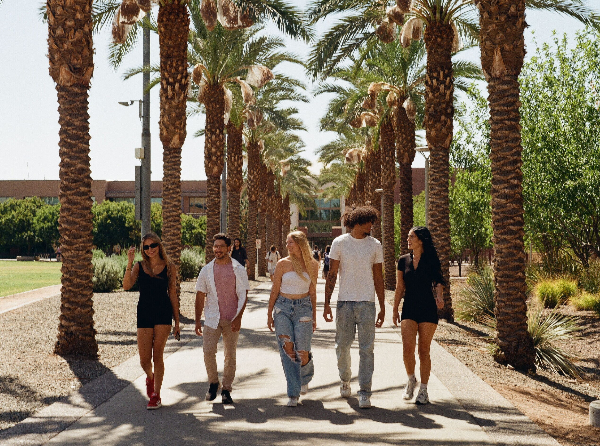 5 ASU Students walking on campus