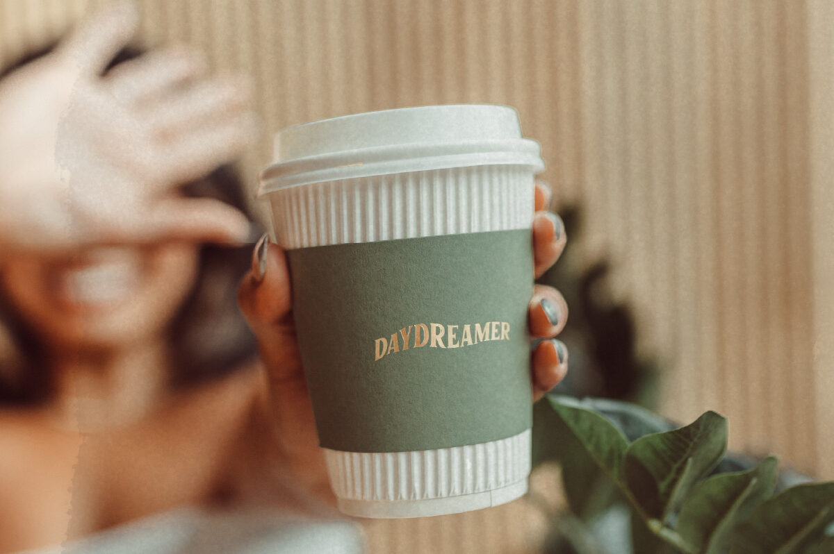 Girl holding daydreamer coffee cup