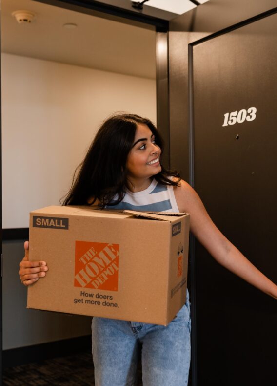 girl moving box to storage