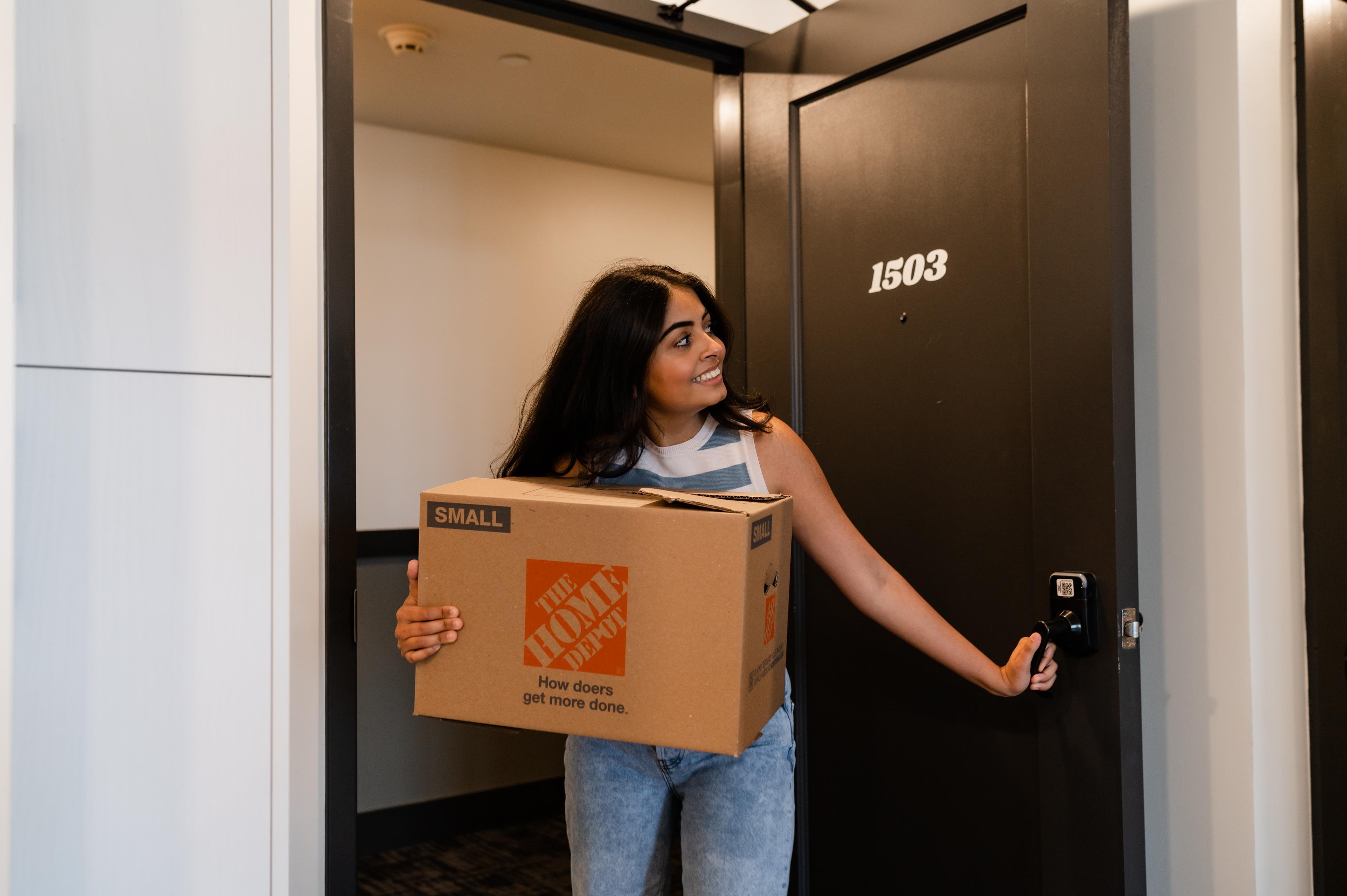 girl moving box to storage