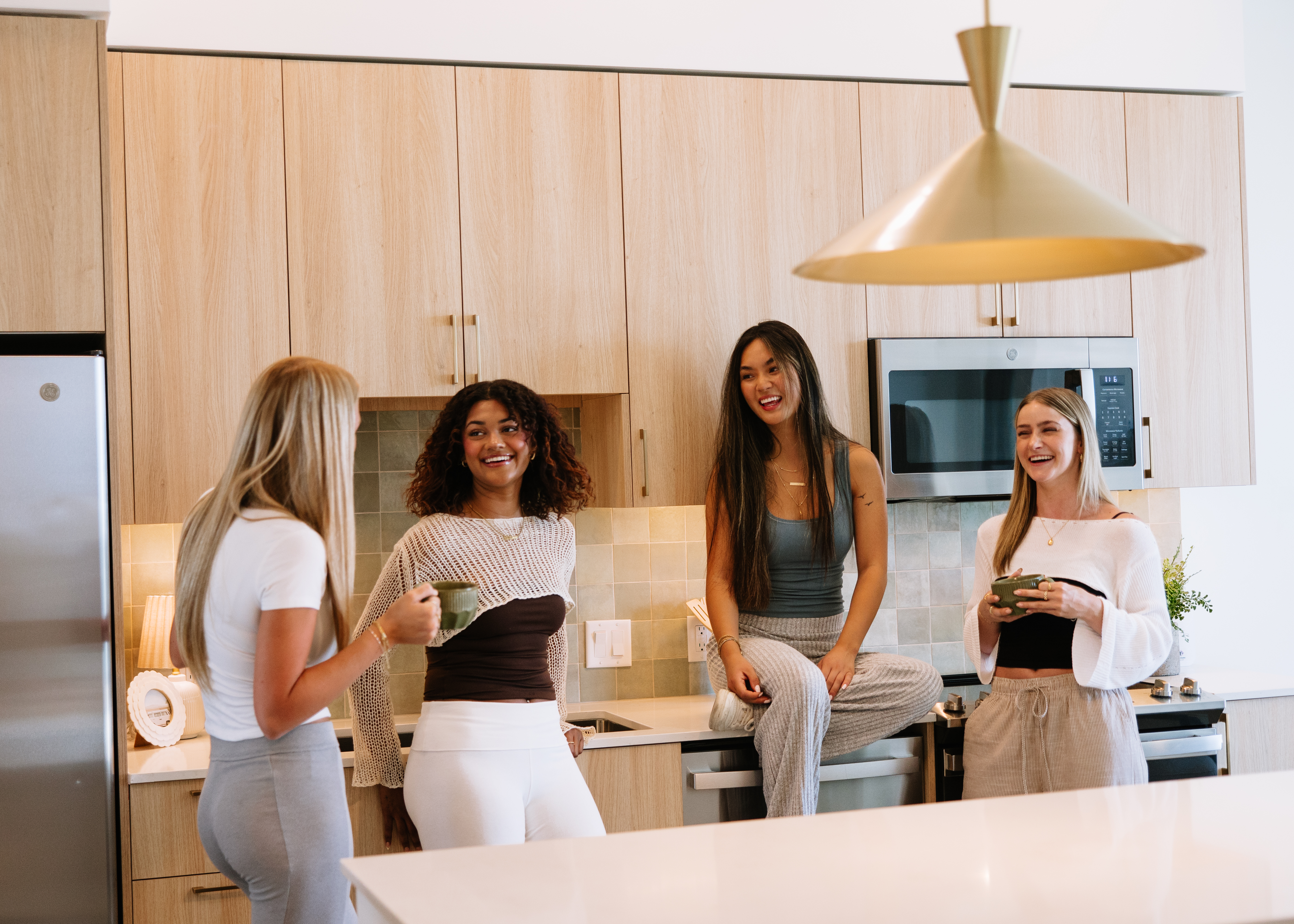 Roommates gathered in their apartment kitchen