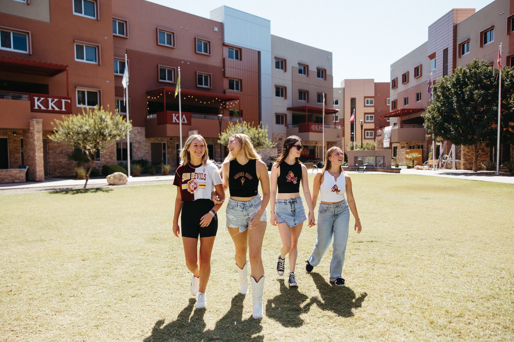 Four ASU students walking on the GLV lawn