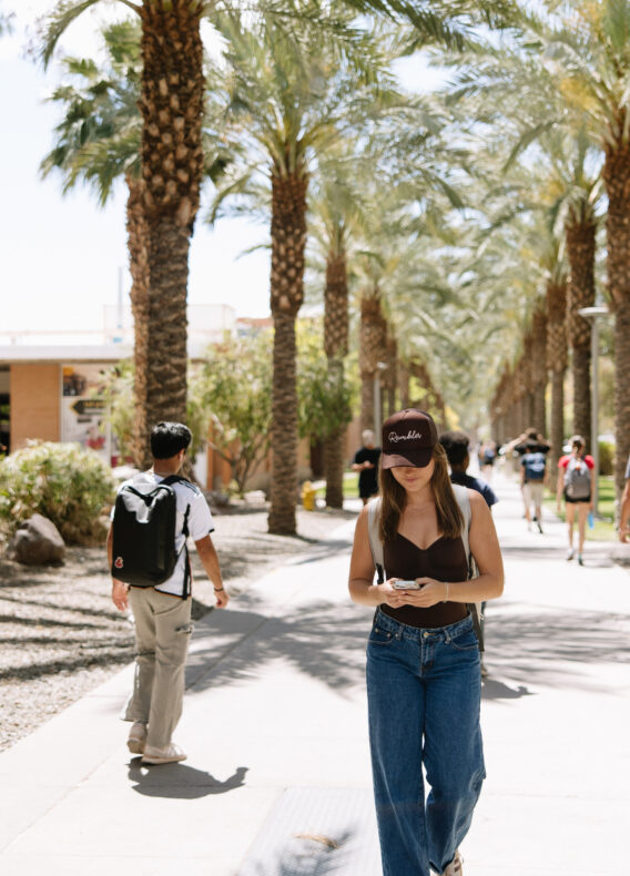 Rambler Tempe ASU student walking through campus texting on phone