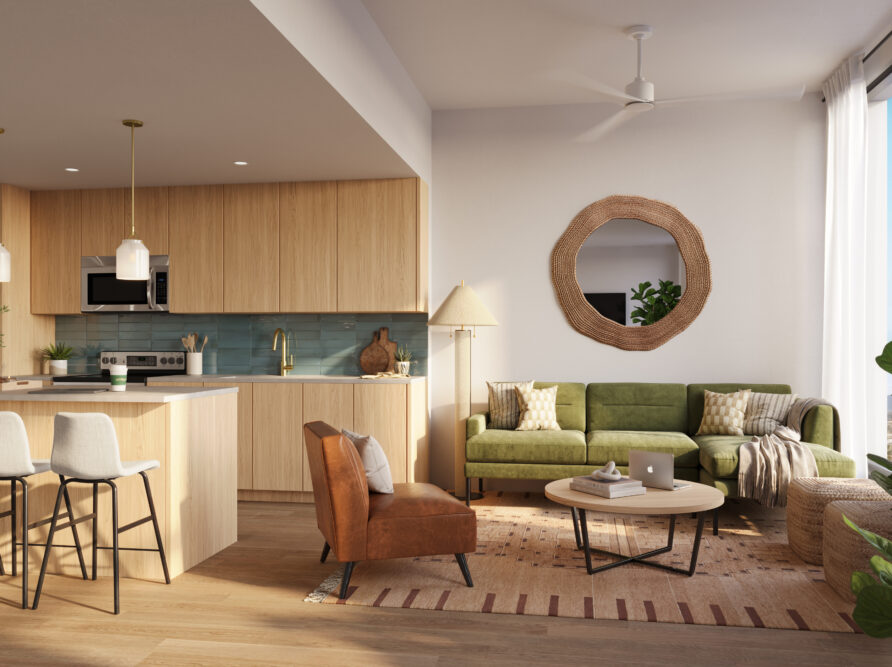 Modern open-concept living room and kitchen with wood accents, a green sofa, brown armchair, round mirror, indoor plants, and barstools at a light wood island. Sunlight streams through large windows.