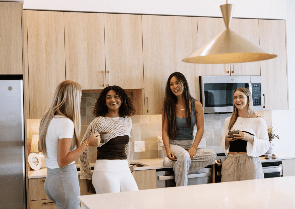 Residents at Rambler Tempe spend time in their apartment kitchen.