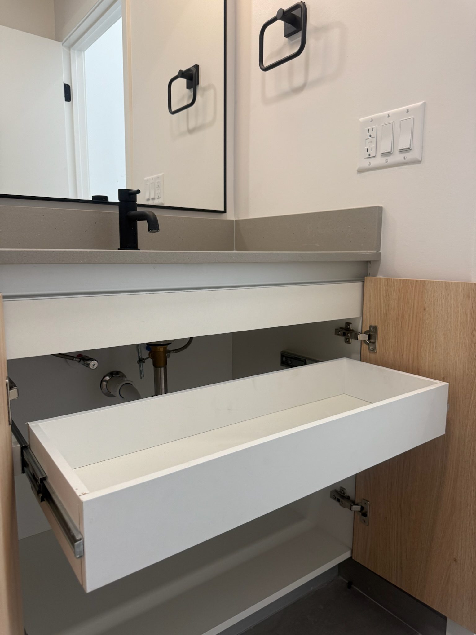 Bathroom vanity with drawers installed across select units.