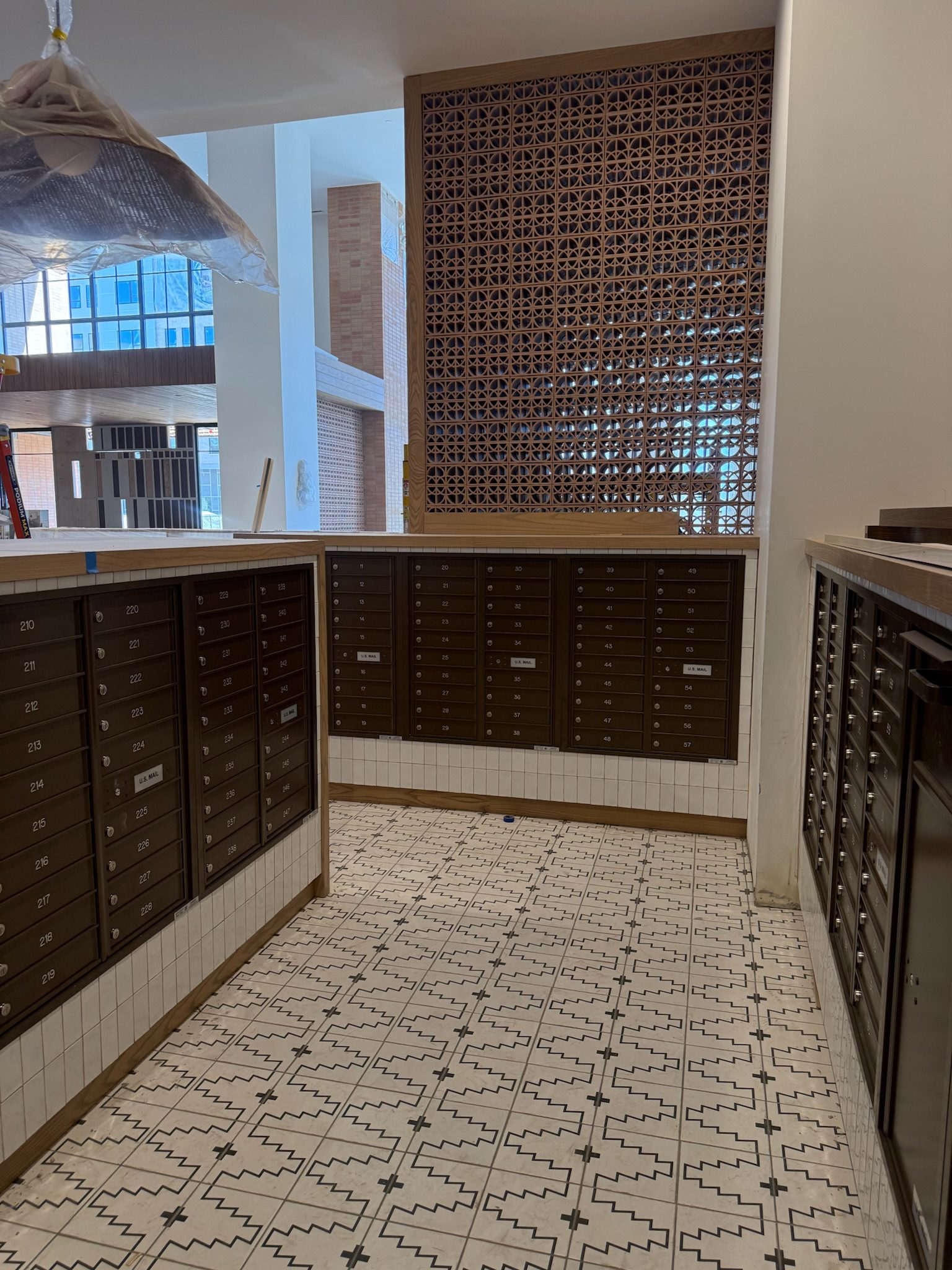 The USPS mailroom fully set up with beautiful patterned tile flooring.