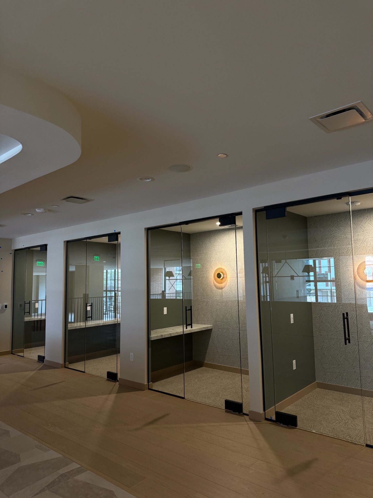 Wallpaper and lighting installed inside the study pods, cozy and ready for residents.
