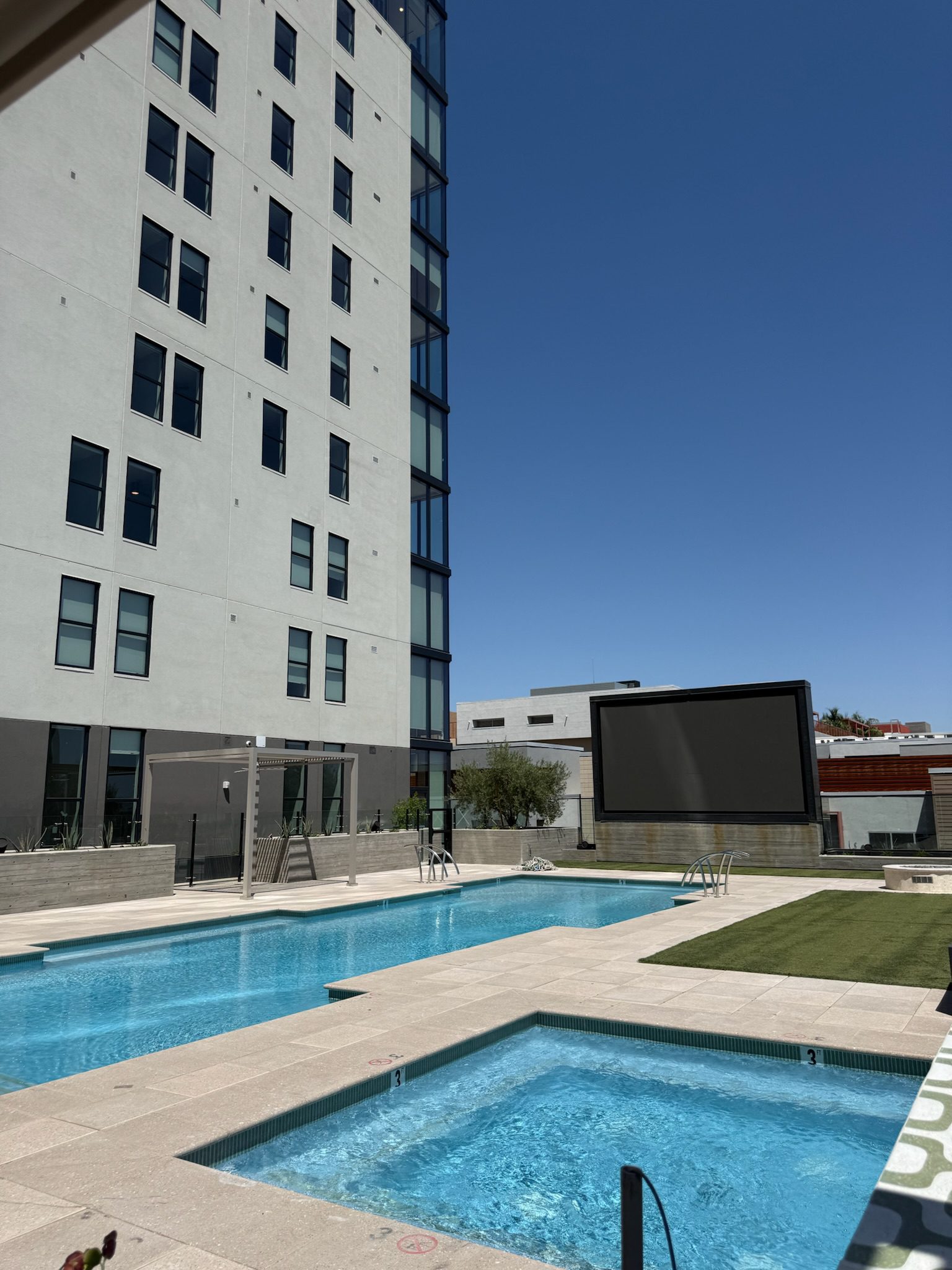 The 5th floor pool and hot tub filled with water, cabana framing up and the jumbotron complete.