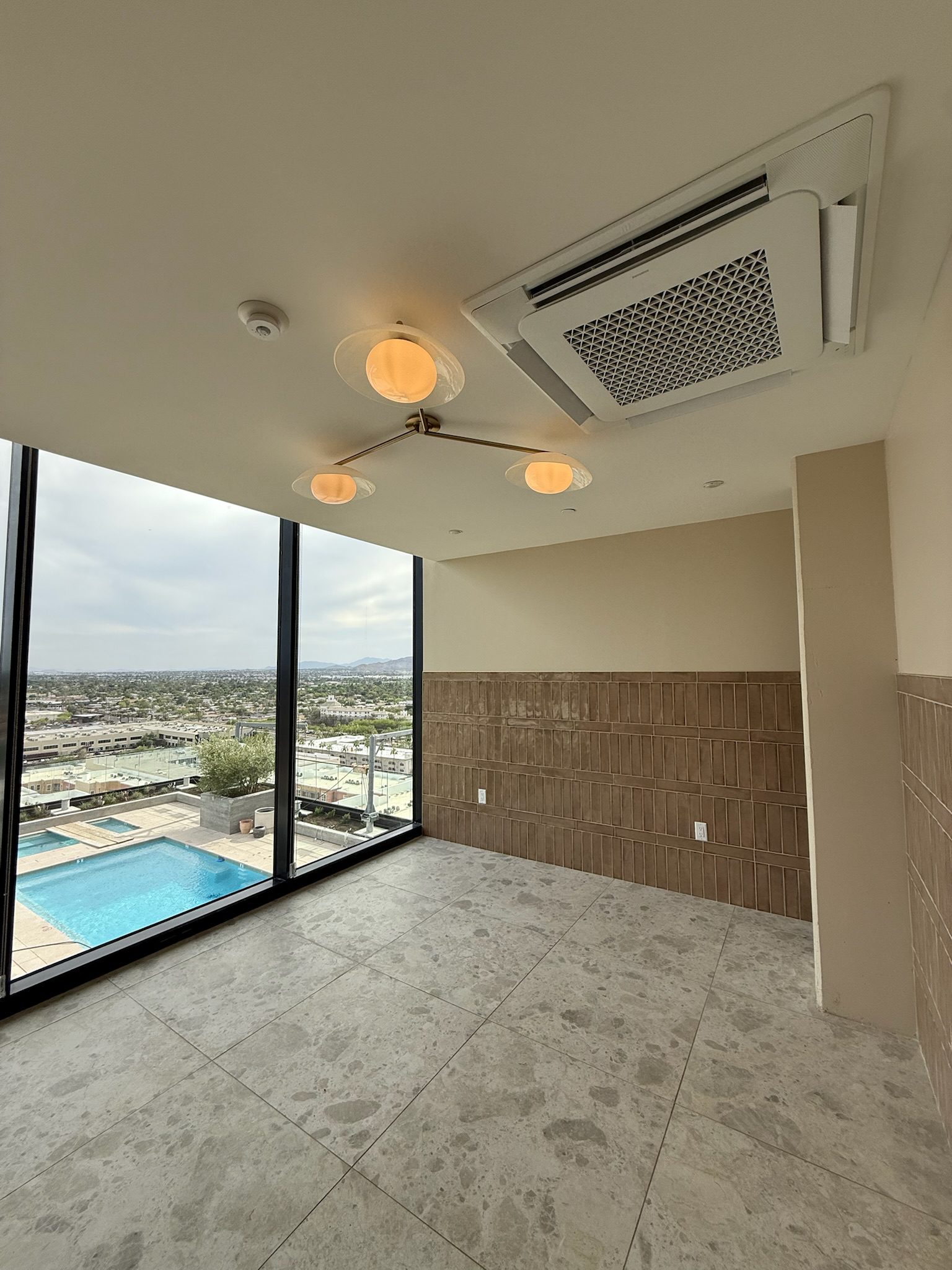 The completed cold plunge room with views of the pool below.