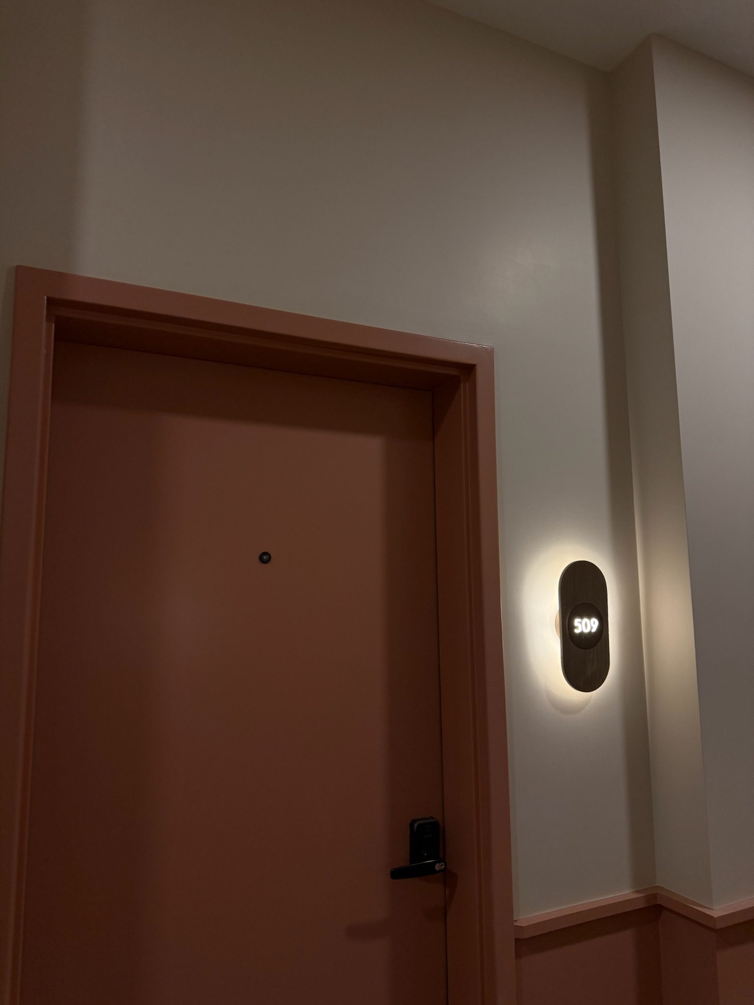 Unit number sconce lighting installed in the corridors, a small detail that makes a big impression.