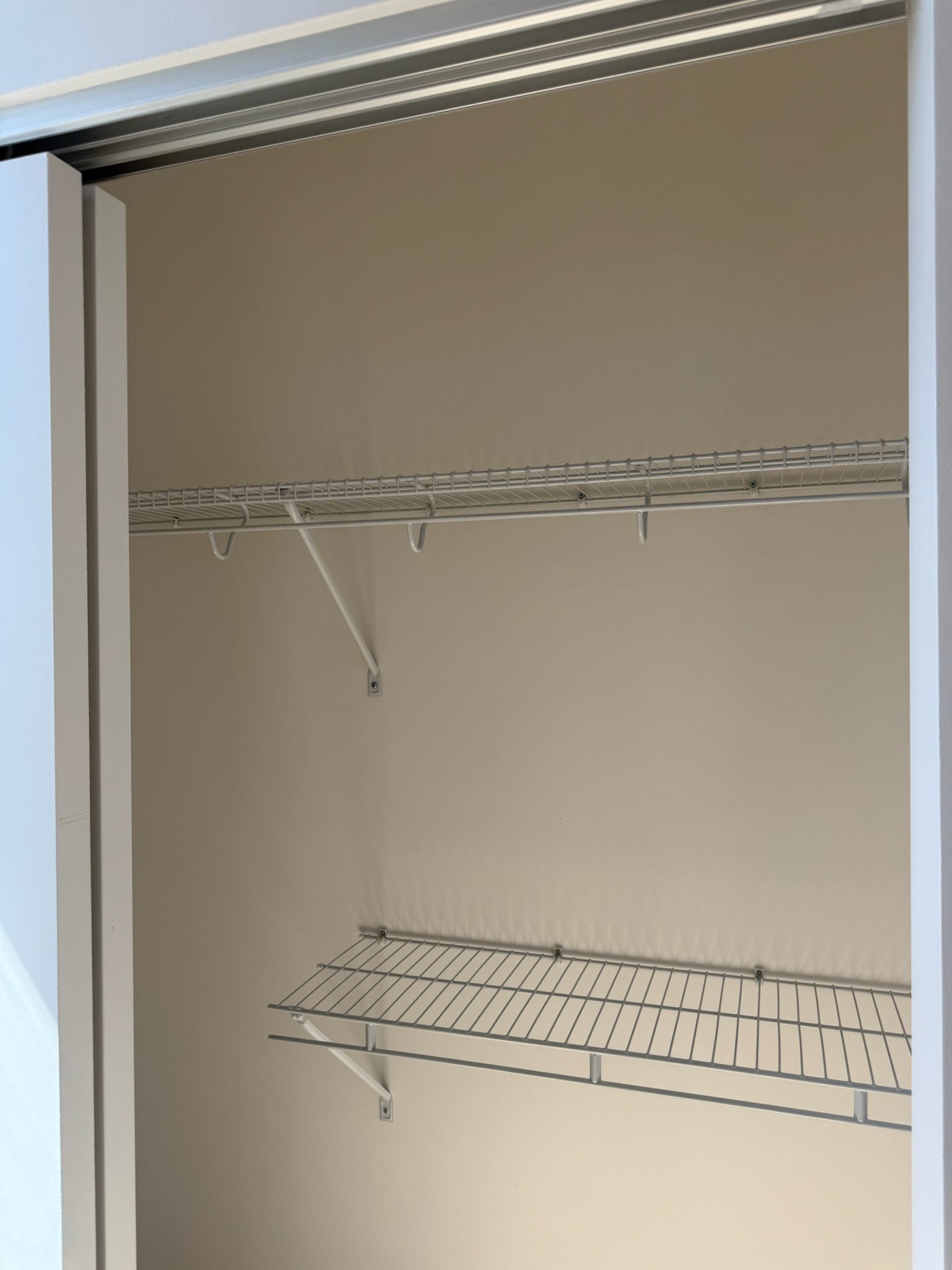 Every closet now features two clothing racks for maximum storage.