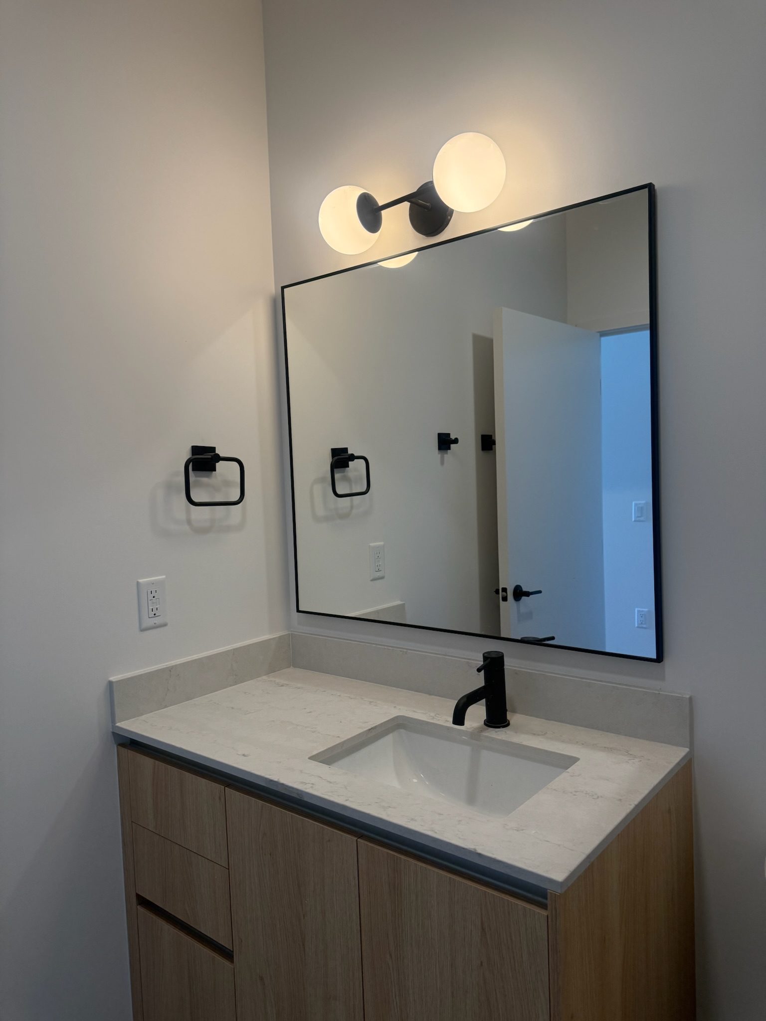 Bathroom vanity with drawers installed across all units.